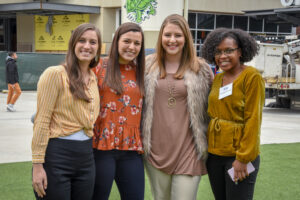 Four women from Women's Operational Resource Group posing for a photo together at an outdoor event supported by Vondace Contracting.