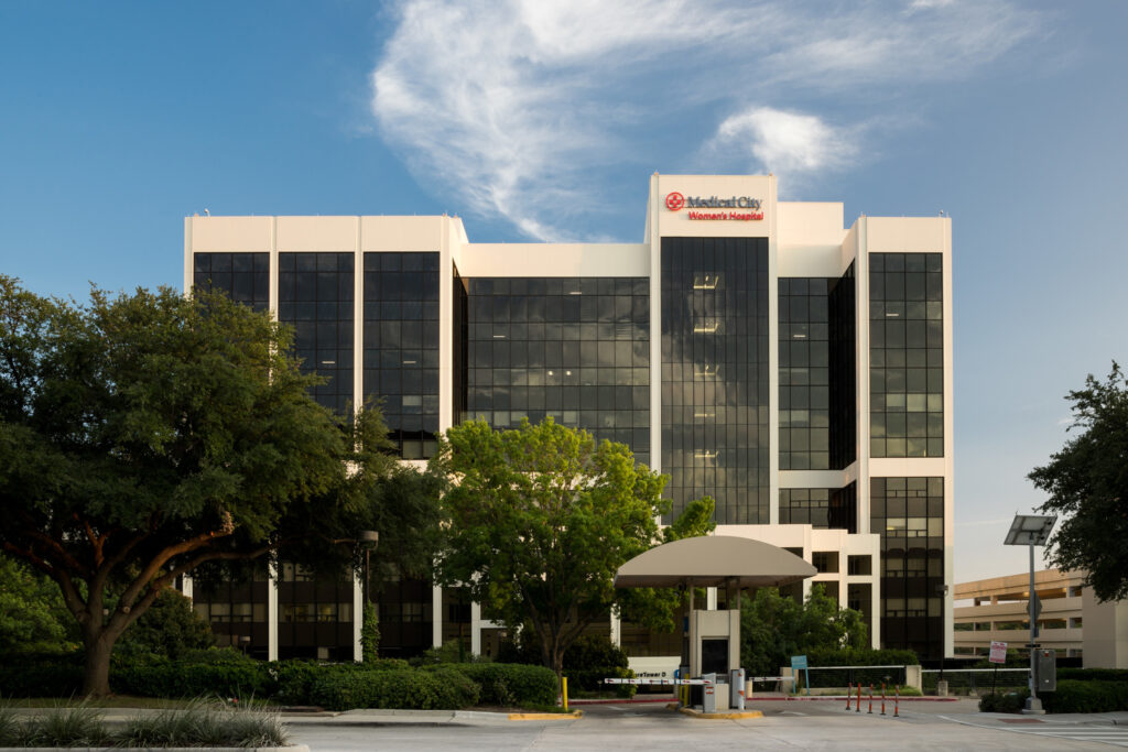 Modern Vondace Contracting Projects' hospital building with a clear blue sky in the background.