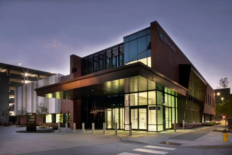 Modern educational building exterior illuminated at dusk.