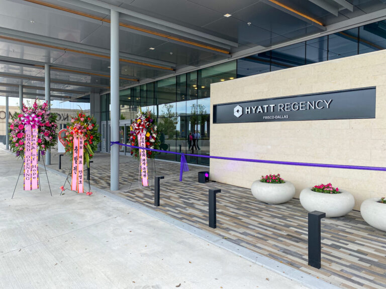 Entrance to the Hyatt Regency Frisco hotel adorned with floral arrangements and ribbons, completed by Vondace Contracting.