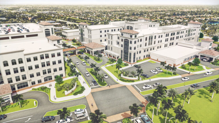 Aerial view of a modern prefabricated hospital complex with surrounding parking and landscaped areas.
