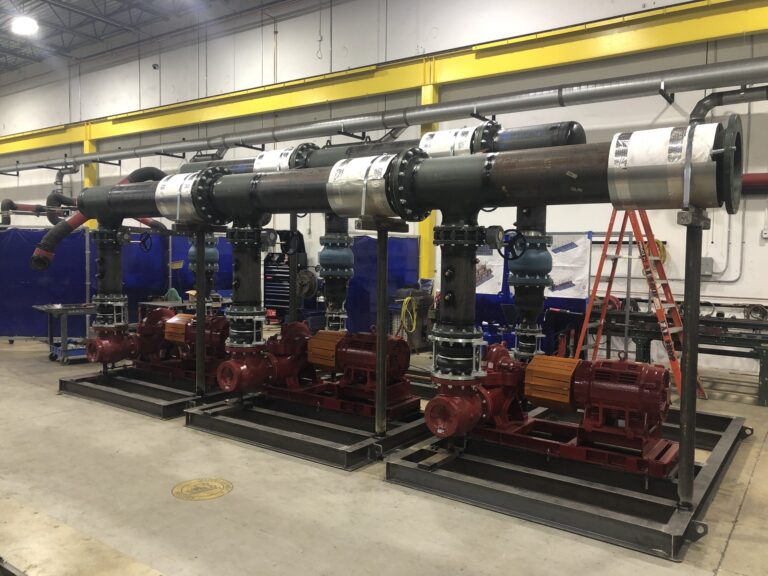Industrial pumps and motors assembly in a manufacturing facility, highlighting success in prefabrication.