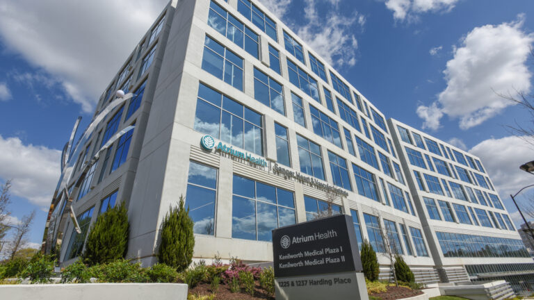 Modern medical facility building, Atrium Health Plaza, on a sunny day.
