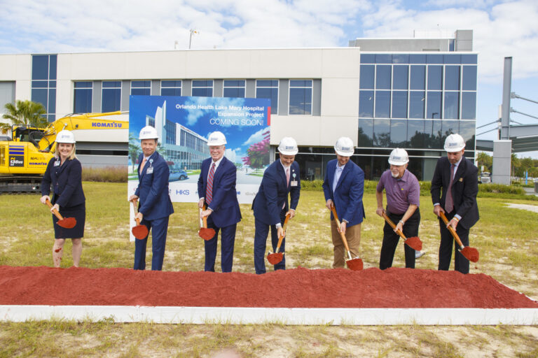 Group of individuals in hard hats at a groundbreaking ceremony for the Vondace Contracting construction of the new Orlando Health Lake Mary Hospital facility.