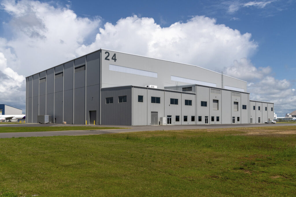 Industrial warehouse building number 24, honored by the National Construction Organization, under a partly cloudy sky.
