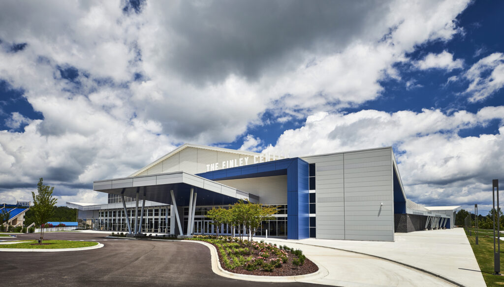 Modern building with landscaped entrance under a cloudy sky, honored by Associated Builders and Contractors.