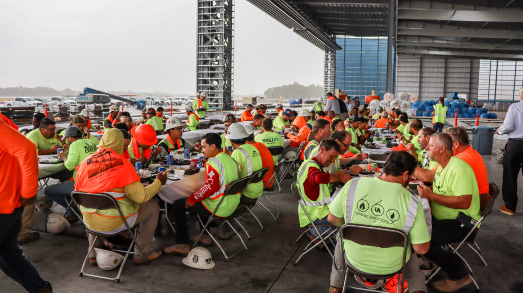 Construction workers taking a meal break at the Vondace Contracting Project Titan worksite.