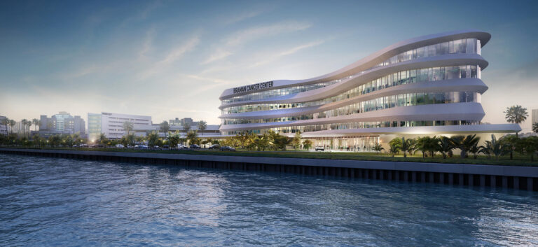 A modern, curvilinear building facade along a waterfront, with ambient evening lighting, showcases Miami's leadership in ENR Southeast construction trends.