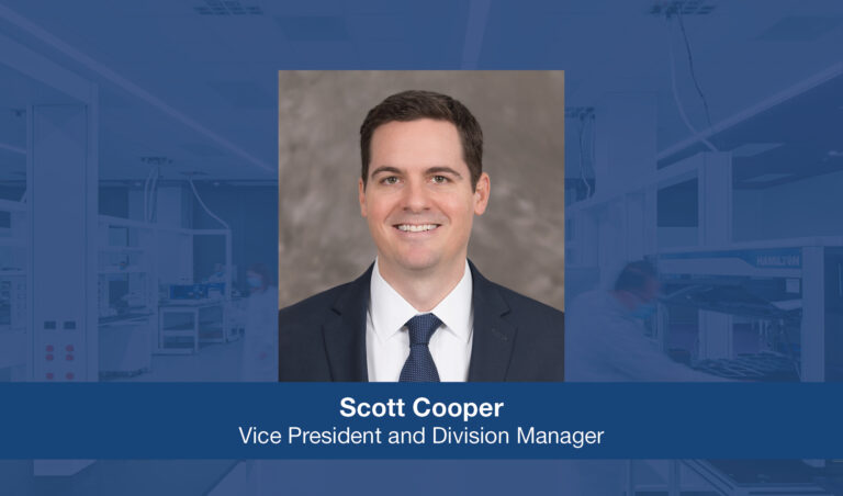 A professional portrait of a smiling man with the name 