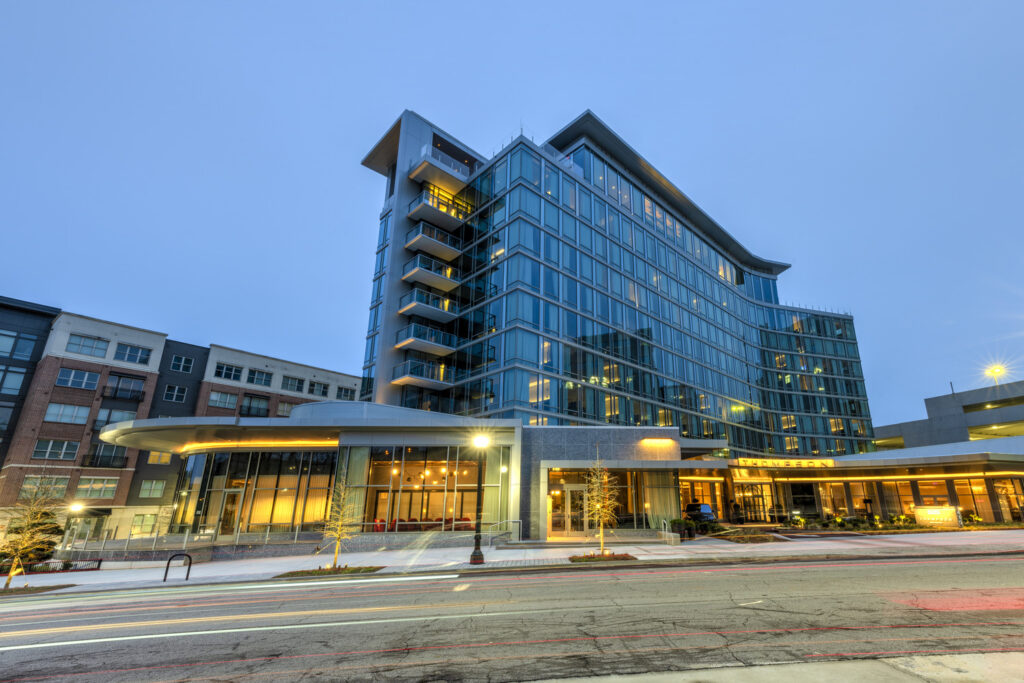 Honored modern glass office building during twilight.