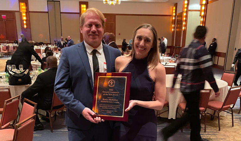 Two individuals posing with the 