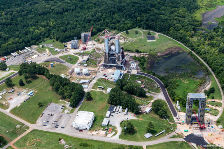 Aerial view of a space launch complex, showcasing Vondace Contracting's role in space exploration infrastructure and vehicles under clear skies.