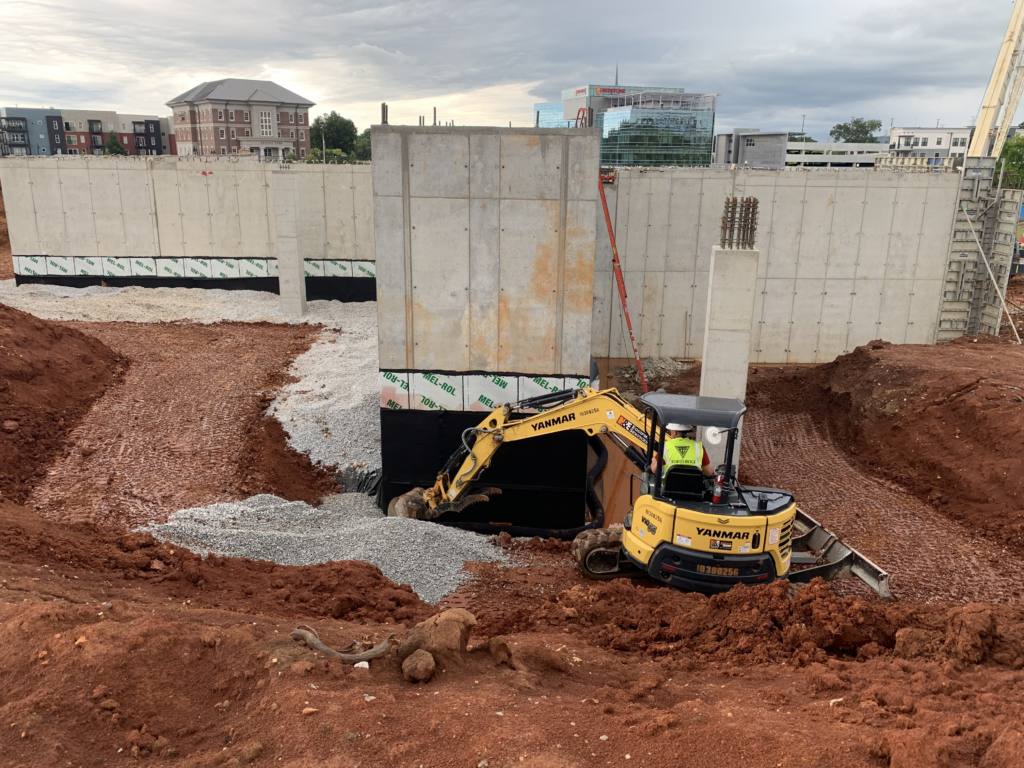 placing bedding stone for foundation drain at the east side of core 2