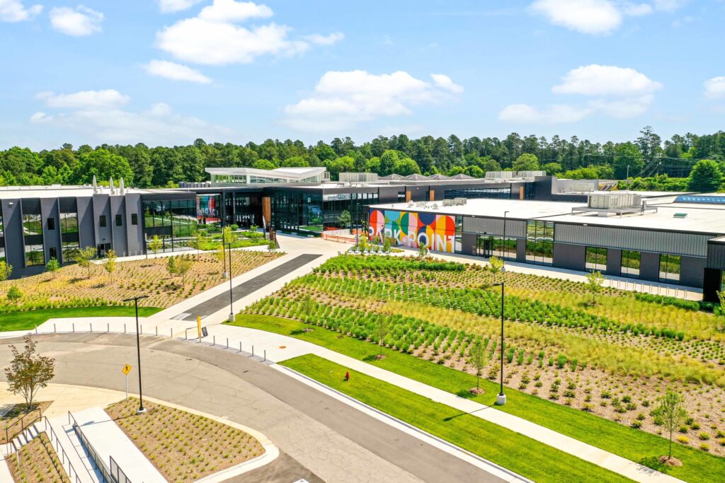 Modern corporate campus with landscaped areas, colorful building facade, and converted spaces.