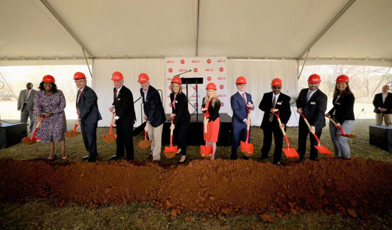 Group of individuals wearing hard hats and holding shovels at a groundbreaking ceremony for Vondace Contracting's new facility.