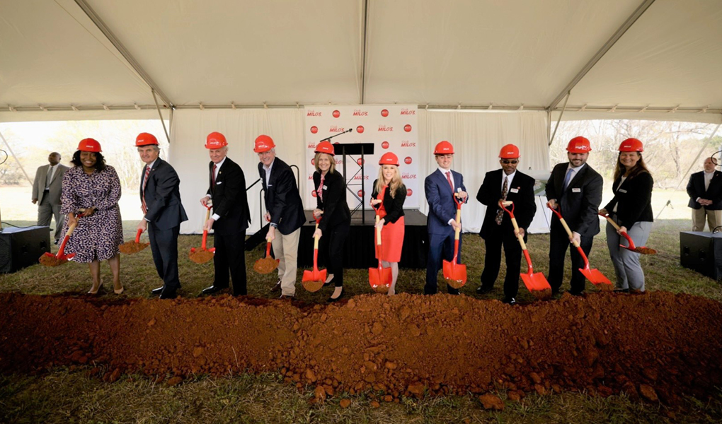 Group of individuals wearing hard hats and holding shovels at a groundbreaking ceremony for Vondace Contracting's new facility.