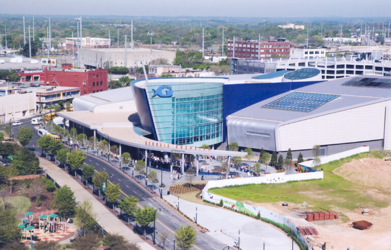 Aerial view of an aquarium with a unique glass façade in an urban setting.