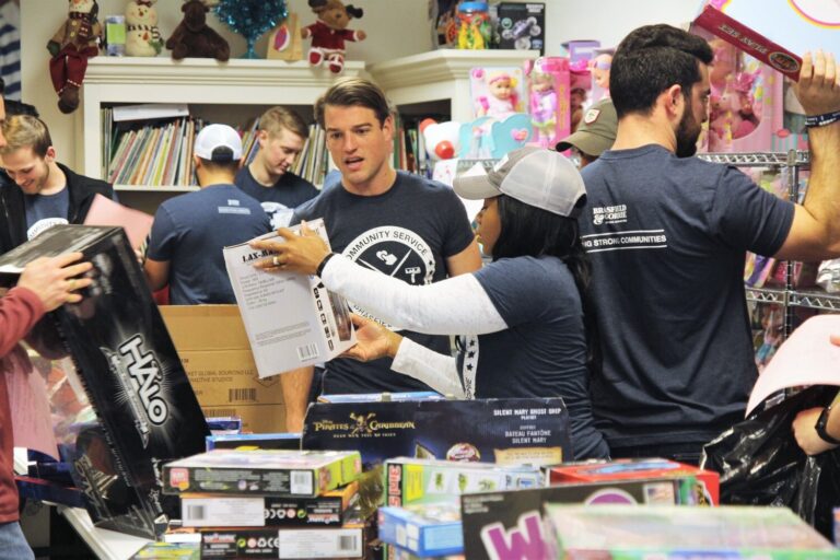 Volunteers sorting and organizing toy donations in a community drive.