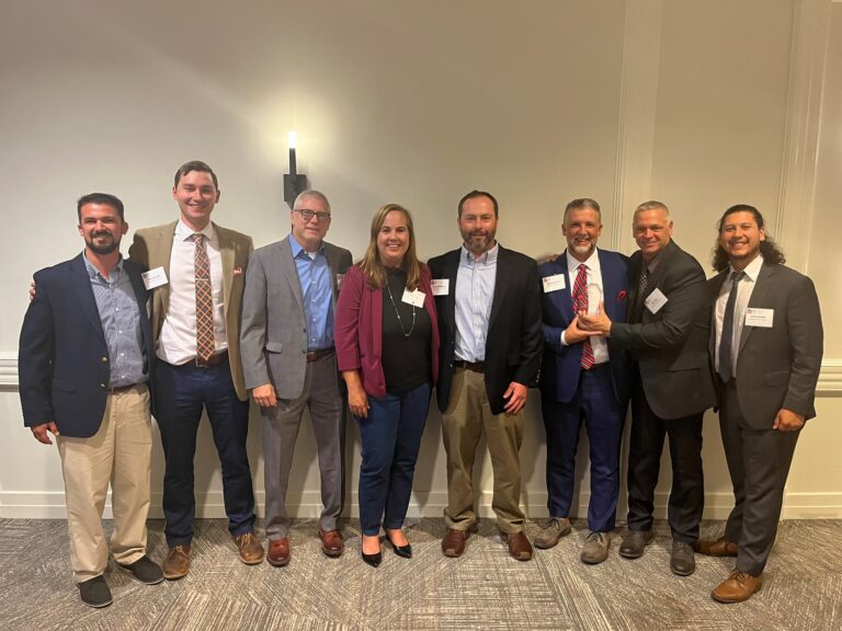 Group of professionals posing together at a formal event in Charlotte, NC.