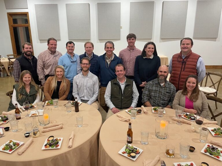 Group of people posing for a photo at a dining event in Jackson, Mississippi.