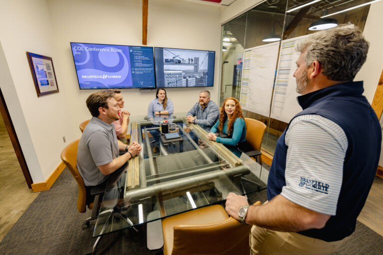 Business colleagues engaged in a discussion in a conference room setting.