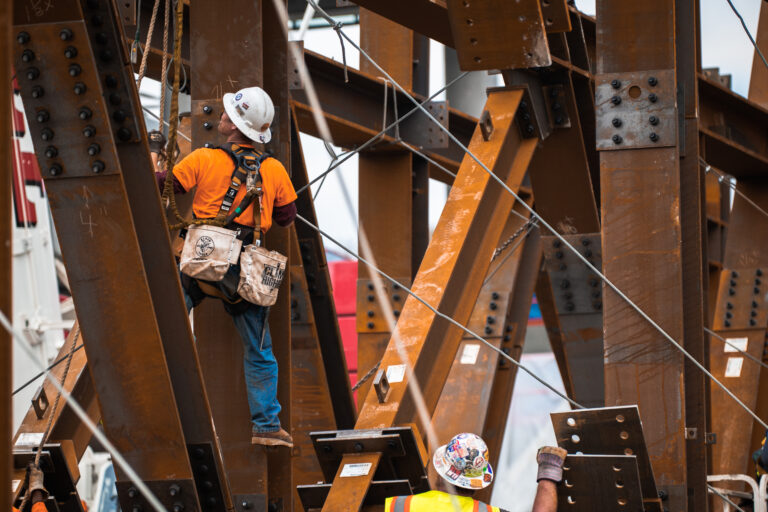 Construction workers engaged in working on a steel structure.