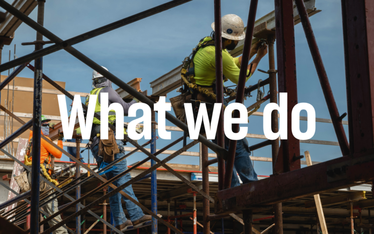 Construction workers in safety gear are diligently working on scaffolding. Large text overlay reads 
